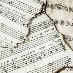 Spalone nuty z zapisem muzycznym, gdzie widać nuty i tekst. Wśród nich odnaleźć można znak bemol w muzyce, świadczący o obniżeniu dźwięku.