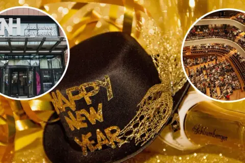 Złota czapka z napisem "Happy New Year", butelka szampana i widok na kino oraz salę koncertową.