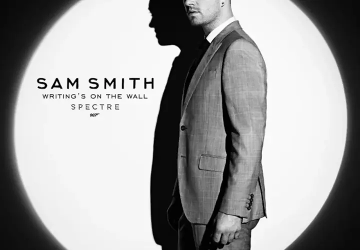 Sam Smith w garniturze, w świetle reflektora, promuje swój utwór "Writing's on the Wall" do filmu o Jamesie Bondzie, Spectre.