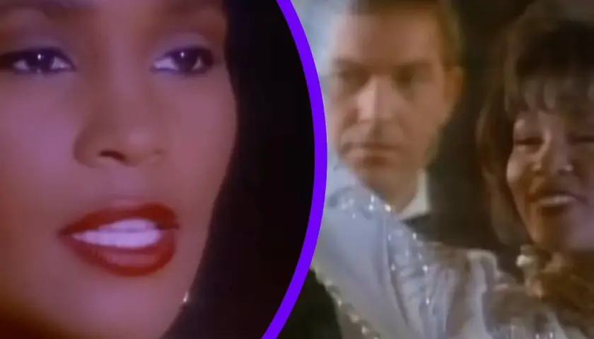 Whitney Houston w klipie "I'm Every Woman", uśmiechnięta, w błyszczącej sukni, obok mężczyzny.