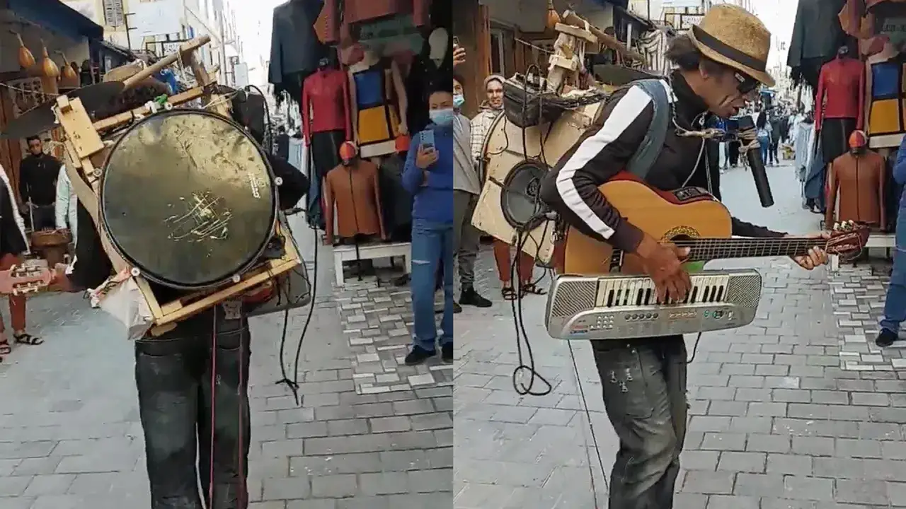 Człowiek orkiestra znaczenie: artysta grający na gitarze, keyboardzie i bębnach jednocześnie na ulicy.